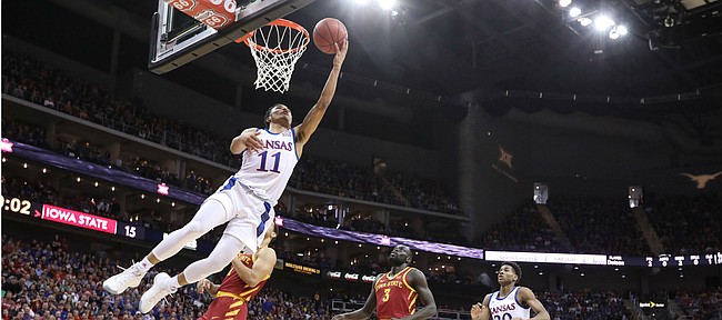 Kansas guard Devon Dotson (11) lunges under the bucket for a shot during the first half, Saturday, March 16, 2019 at Sprint Center in Kansas City, Mo.