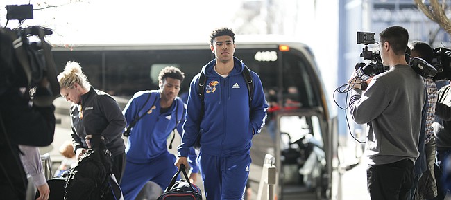 Kansas guards Quentin Grimes and Ochai Agbaji head into the team hotel upon their arrival in Salt Lake City, Utah. The Jayhawks will practice on Wednesday in preparation for their opening round game against the Northeastern Huskies.
