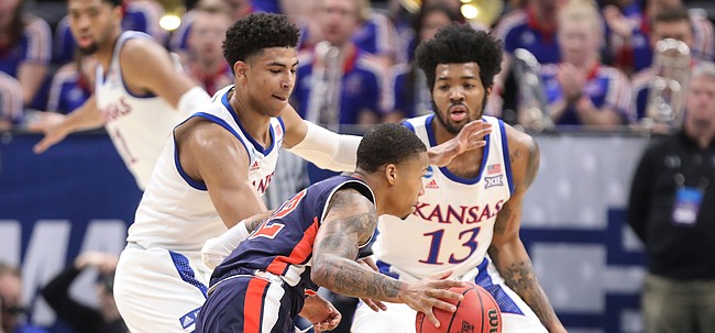 Kansas guard Quentin Grimes (5) and Kansas guard K.J. Lawson (13) defend against Auburn guard Will Macoy (22) during the first half on Saturday, March 23, 2019 at Vivint Smart Homes Arena in Salt Lake City, Utah.