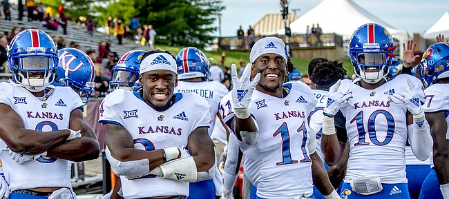 A contingent of Kansas football defensive players — from left, Elmore Hempstead Jr., Elijah Jones, Najee Stevens-McKenzie, Ricky Thomas, Mike Lee and Julian Chandler — pose on the sideline as the Jayhawks wrap up a road win at Central Michigan.