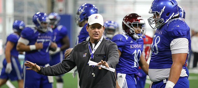 Kansas head coach Les Miles works with offensive lineman Api Mane on Thursday, April 4, 2019 at the indoor practice facility.