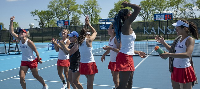The Kansas tennis team celebrates a a 4-2 win against Florida on Saturday, May 4, 2019, at the Jayhawk Tennis Center. The win moved Kansas into the Sweet 16. 