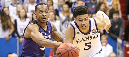 Kansas guard Quentin Grimes (5) and Kansas State guard Barry Brown Jr. (5) run down a loose ball during the second half, Monday, Feb. 25, 2019 at Allen Fieldhouse.