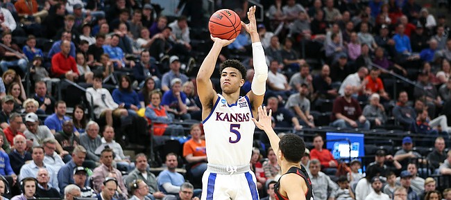 Kansas guard Quentin Grimes (5) puts up a three over Northeastern guard Jordan Roland (12) during the second half, Thursday, March 21, 2019 at Vivint Smart Homes Arena in Salt Lake City, Utah.