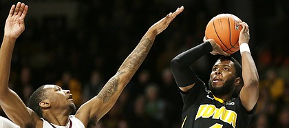 Iowa guard Isaiah Moss(4) shoots in front of Minnesota guard Dupree McBrayer (1) during the second half of an NCAA college basketball game Sunday, Jan. 27, 2019, in Minneapolis.


