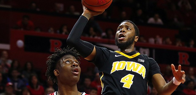 Iowa guard Isaiah Moss (4) shoots over Rutgers forward Shaq Carter (13) during the first half of an NCAA college basketball game Saturday, Feb. 16, 2019, in Piscataway, N.J.


