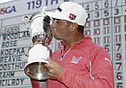 Gary Woodland posses with the trophy after winning the U.S. Open Championship golf tournament Sunday, June 16, 2019, in Pebble Beach, Calif. (AP Photo/Carolyn Kaster)