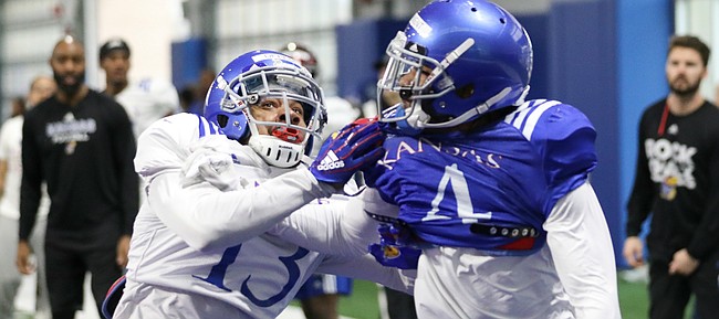 Kansas cornerback Hasan Defense (3) works for position against receiver Andrew Parchment as they compete for a throw to the end zone on Thursday, April 4, 2019 at the indoor practice facility.