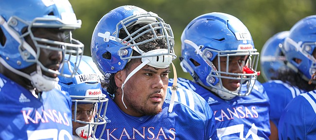 Kansas center Api Mane watches two teammates in the Jayhawk drill during practice on Friday, Aug. 9, 2019.