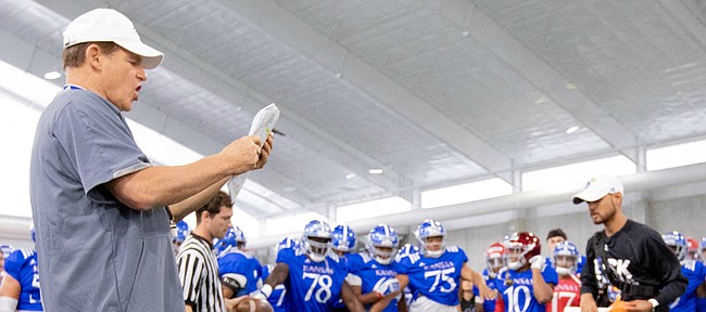Kansas head coach Les Miles calls out players to go head-to-head in the Jayhawk drill during practice on Thursday, Aug. 8, 2019.