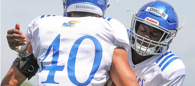 Kansas linebacker Kyron Johnson works on technique with fellow position player Dru Prox during practice on Friday, Aug. 9, 2019.