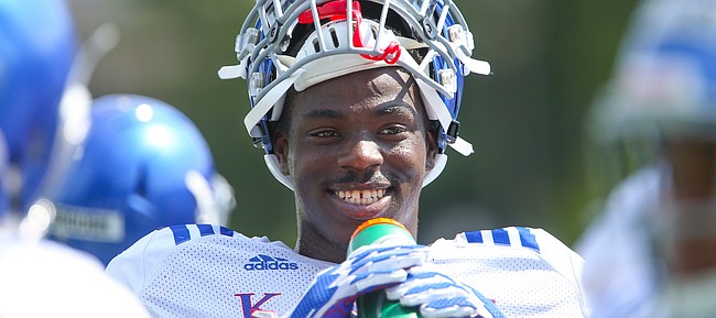 Kansas linebacker Steven Parker gets a drink during a break from practice on Friday, Aug. 9, 2019.