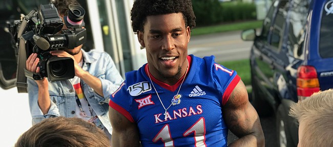 Kansas senior safety Mike Lee speaks with a group of young fans on Friday, Aug. 23, 2019, during the athletic department’s annual KU Kickoff at Corinth Square, in Prairie Village.
