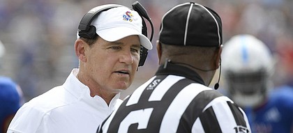 Kansas head coach Les Miles talks with a ref during the game against Indiana State Saturday afternoon at David Booth Kansas Memorial Stadium. 