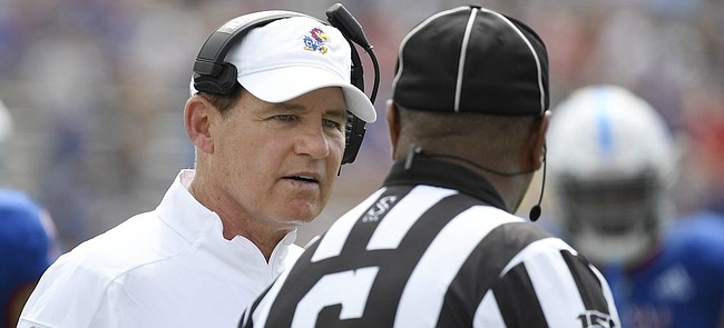 Kansas head coach Les Miles talks with a ref during the game against Indiana State Saturday afternoon at David Booth Kansas Memorial Stadium. 