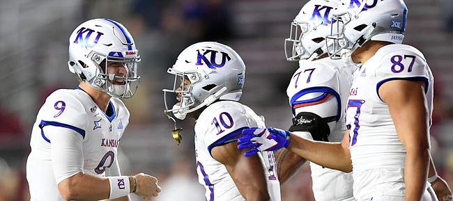 (Boston, MA, 09/13/19) Kansas Jayhawks teammates Carter Stanley, left, Khalil Herbert, Andru Tovi, and Jack Luavasa celebrate a touchdown against the Boston College Eagles during the second half of an NCAA football game in Boston, Mass., on Friday, September 13, 2019.