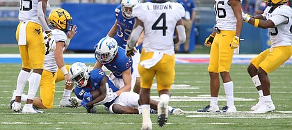 Kansas wide receiver Jamahl Horne (88) falls on an onside kick during the third quarter on Saturday, Sept. 21, 2019 at David Booth Kansas Memorial Stadium. Interference was called on the play and the ball was awarded to West Virginia.