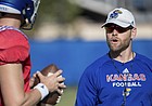 New Kansas offensive coordinator Brent Dearmon breaks down a drill with the KU quarterbacks, including starter Carter Stanley, during a recent practice. 