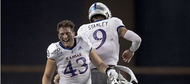 Kansas quarterback Carter Stanley (9) celebrates a touchdown against Texas with linebacker Jay Dineen (43) during an NCAA college football game Saturday, Oct. 19, 2019, in Austin, Texas. (Nick Wagner/Austin American-Statesman via AP)