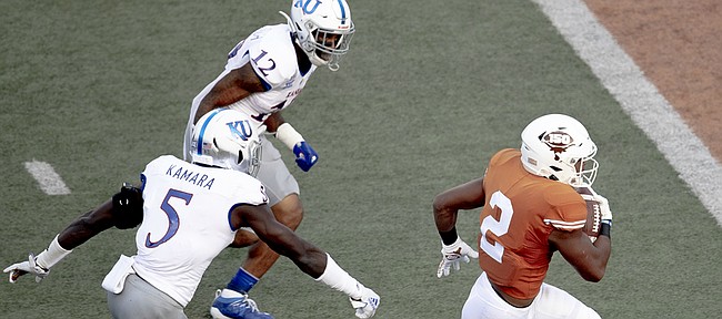Texas running back Roschon Johnson (2) scores a touchdown against Kansas during an NCAA college football game Saturday, Oct. 19, 2019, in Austin, Texas. (Nick Wagner/Austin American-Statesman via AP)