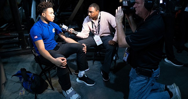 Kansas point guard Devon Dotson sits for an interview during Big 12 Media Day on Wednesday, Oct. 23, 2019 at Sprint Center in Kansas City. Dotson is wearing a boot on his right foot after sustaining an injury during practice on Tuesday.