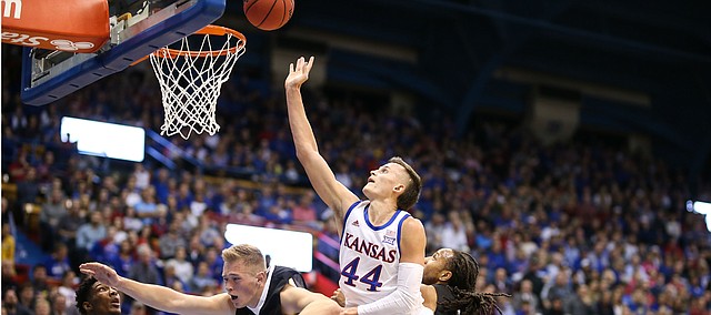 Kansas forward Mitch Lightfoot (44) comes over the top of Fort Hays State forward Jared Vitztum (21) while fighting for a ball during the first half, Thursday, Oct. 24, 2019 at Allen Fieldhouse.
