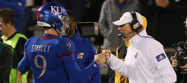 Kansas football Les Miles, right, greets Carter Stanley (9) after Stanley threw for a touchdown in the second half of KU's 37-34 win against Texas Tech.