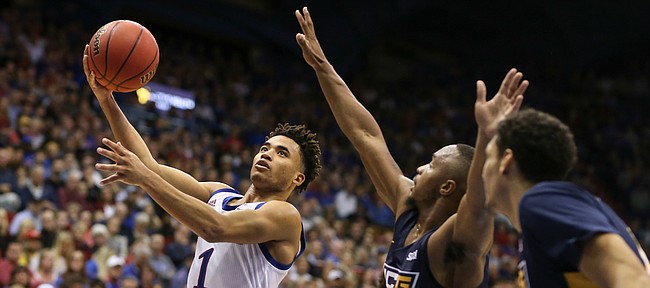 Kansas guard Devon Dotson (1) floats in for a bucket against UNC-Greensboro guard Malik Massey (2) during the second half, Friday, Nov. 8, 2019 at Allen Fieldhouse.