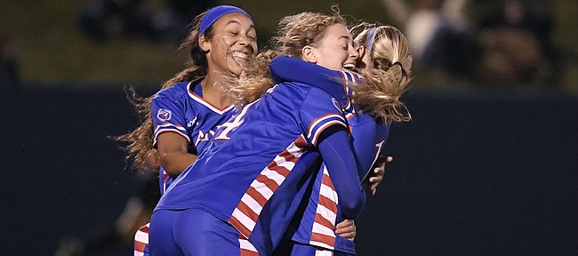 Kailey Lane (center), Sam Barnett (left), and Katie McClure (right) celebrate a goal by Lane against Iowa Saturday night at Rock Chalk Park on Nov. 16, 2019.