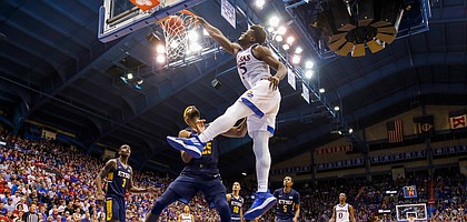 Kansas center Udoka Azubuike (35) powers in a dunk against East Tennessee State center Lucas N'Guessan (25) during the second half on Tuesday, Nov. 19, 2019 at Allen Fieldhouse.