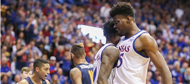 Kansas center Udoka Azubuike (35) bumps chests with Kansas guard Marcus Garrett (0) after Garrett finished a bucket with a foul during the first half on Tuesday, Nov. 19, 2019 at Allen Fieldhouse.