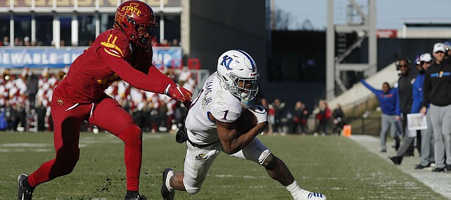 Iowa State defensive back Lawrence White, left, chases down Kansas running back Pooka Williams, right, during the second half of an NCAA college football game, Saturday, Nov. 23, 2019, in Ames, Iowa. Iowa State won 41-31. (AP Photo/Matthew Putney)