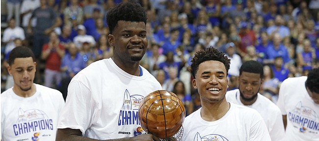 Kansas center Udoka Azubuike, left, and guard Devon Dotson share the Maui Invitational co-MVP trophy, Wednesday, Nov. 27, 2019, in Lahaina, Hawaii. Kansas defeated Dayton in 90-84 in overtime in an NCAA college basketball game for the tournament title. (AP Photo/Marco Garcia)