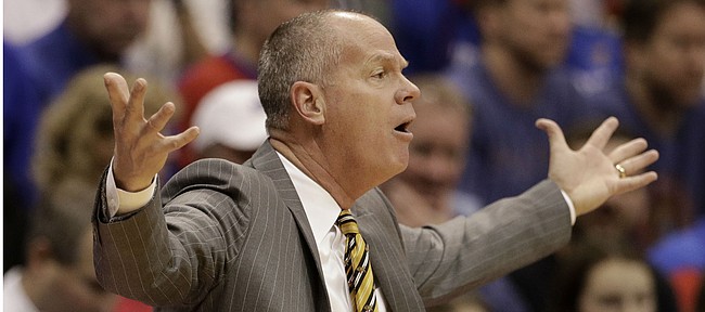 Colorado head coach Tad Boyle questions a call during the first half of an NCAA college basketball game against Kansas, Saturday, Dec. 7, 2019, in Lawrence, Kan. (AP Photo/Charlie Riedel)