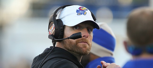 Kansas offensive coordinator Brent Dearmon turns over his shoulder as he looks down the sideline during the fourth quarter on Saturday, Nov. 2, 2019 at Memorial Stadium.