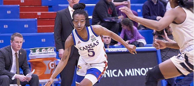 Kansas sophomore Aniya Thomas (5) makes a move to drive to the rim during KU's nonconference finale Monday night at Allen Fieldhouse on Dec. 30, 2019.