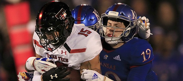 Texas Tech tight end Travis Koontz (15) is tackled by Kansas linebacker Gavin Potter (19) during the first half of an NCAA college football game in Lawrence, Kan., Saturday, Oct. 26, 2019. (AP Photo/Orlin Wagner)