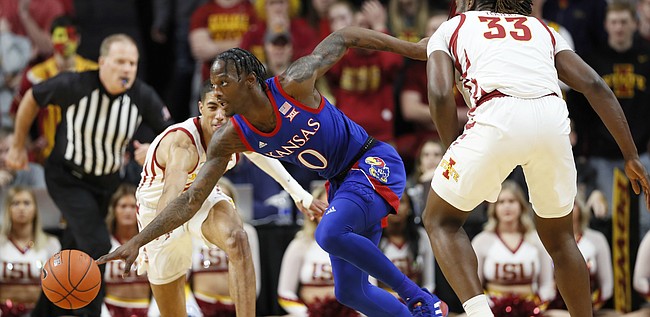 Kansas guard Marcus Garrett (0) races for the ball between Iowa State's Tyrese Haliburton and Solomon Young, right, during the first half of an NCAA college basketball game Wednesday, Jan. 8, 2020, in Ames, Iowa. (AP Photo/Charlie Neibergall)