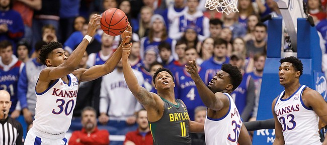 Kansas Jayhawks guard Ochai Agbaji (30) comes away with an offensive rebound from Baylor Bears guard Mark Vital (11) during the first half on Saturday, Jan. 11, 2020 at Allen Fieldhouse.