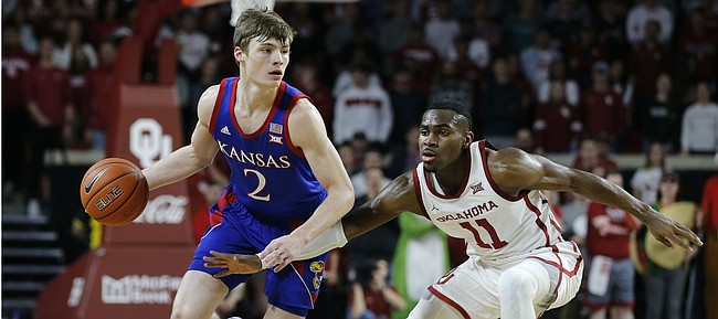 Kansas' Christian Braun (2) is defended by Oklahoma's De'Vion Harmon (11) during the first half of an NCAA college basketball game in Norman, Okla., Tuesday, Jan. 14, 2020.