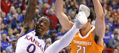 Kansas guard Marcus Garrett (0) is sent to the floor after a hard foul from Tennessee forward Olivier Nkamhoua (21) during the first half, Saturday, Jan. 25, 2019 at Allen Fieldhouse.