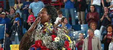 Former Kansas University women's basketball coach Marian Washington, center, kisses the crowd goodbye before KU's game against Nebraska on Saturday, Feb. 28, 2004, when Washington officially retired at Allen Fieldhouse.

