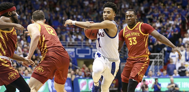 Kansas guard Devon Dotson (1) makes a move to the bucket against several Iowa State defenders during the second half on Monday, Feb. 17, 2020 at Allen Fieldhouse.