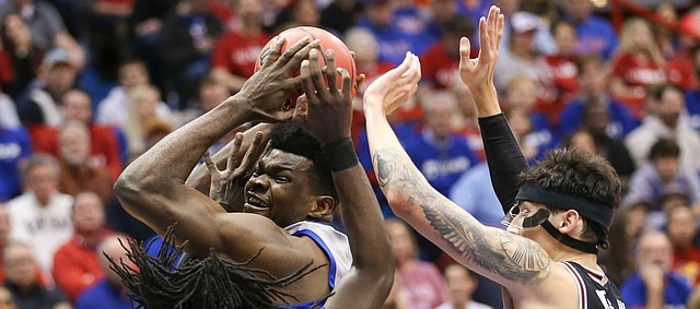 Kansas center Udoka Azubuike is doubled teamed by Oklahoma State guard Isaac Likekele (13) and Oklahoma State guard Lindy Waters III (21) during the first half on Monday, Feb. 24, 2020 at Allen Fieldhouse.