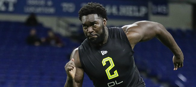 Kansas offensive lineman Hakeem Adeniji runs a drill at the NFL football scouting combine in Indianapolis, Friday, Feb. 28, 2020. (AP Photo/Michael Conroy)