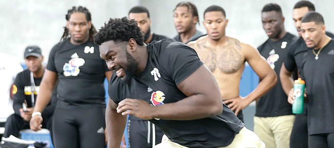Kansas offensive lineman Hakeem Adeniji sprints off of a line while running a shuttle drill during Pro Day on Thursday, March 5, 2020 in the indoor practice facility.