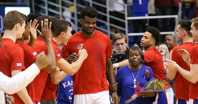 Kansas center Udoka Azubuike (35) is cheered by his teammates as he is introduced to the Allen Fieldhouse crowd on Senior Night.