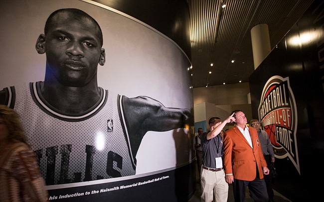 Kansas head coach Bill Self makes his way past a large portrait of Michael Jordan as he takes a tour through the Naismith Memorial Basketball Hall of Fame in Springfield, Massachusetts following a jacket presentation ceremony on Thursday, Sept. 7, 2017. On Friday, Self will be inducted into the Hall of Fame