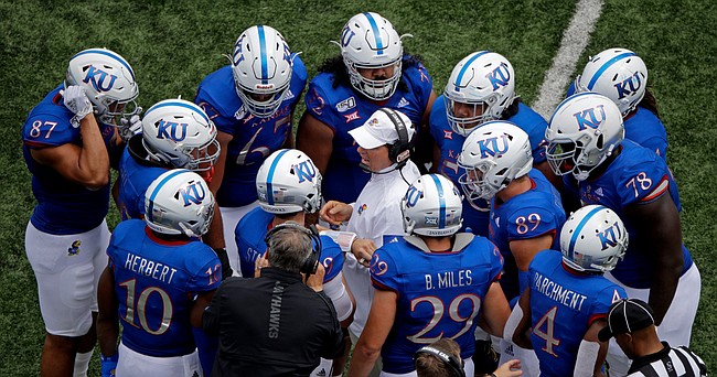 Kansas head coach Les Miles talks to his players during a time out in the second half of an NCAA college football game against Indiana State, Saturday, Aug. 31, 2019, in Lawrence, Kan. Kansas won 24-17. AP Photo/Charlie Riedel)