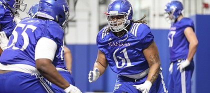 Kansas offensive lineman Malik Clark works with his fellow position players on Thursday, April 4, 2019 at the indoor practice facility.